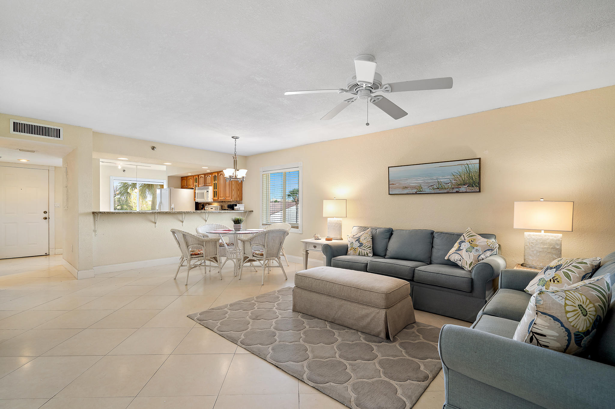 275 Palm Avenue, Unit C201 Jupiter, FL 33477 - Photo 14 of 24 a living room with furniture and a view of kitchen