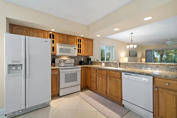 a kitchen with granite countertop a sink and a counter top space