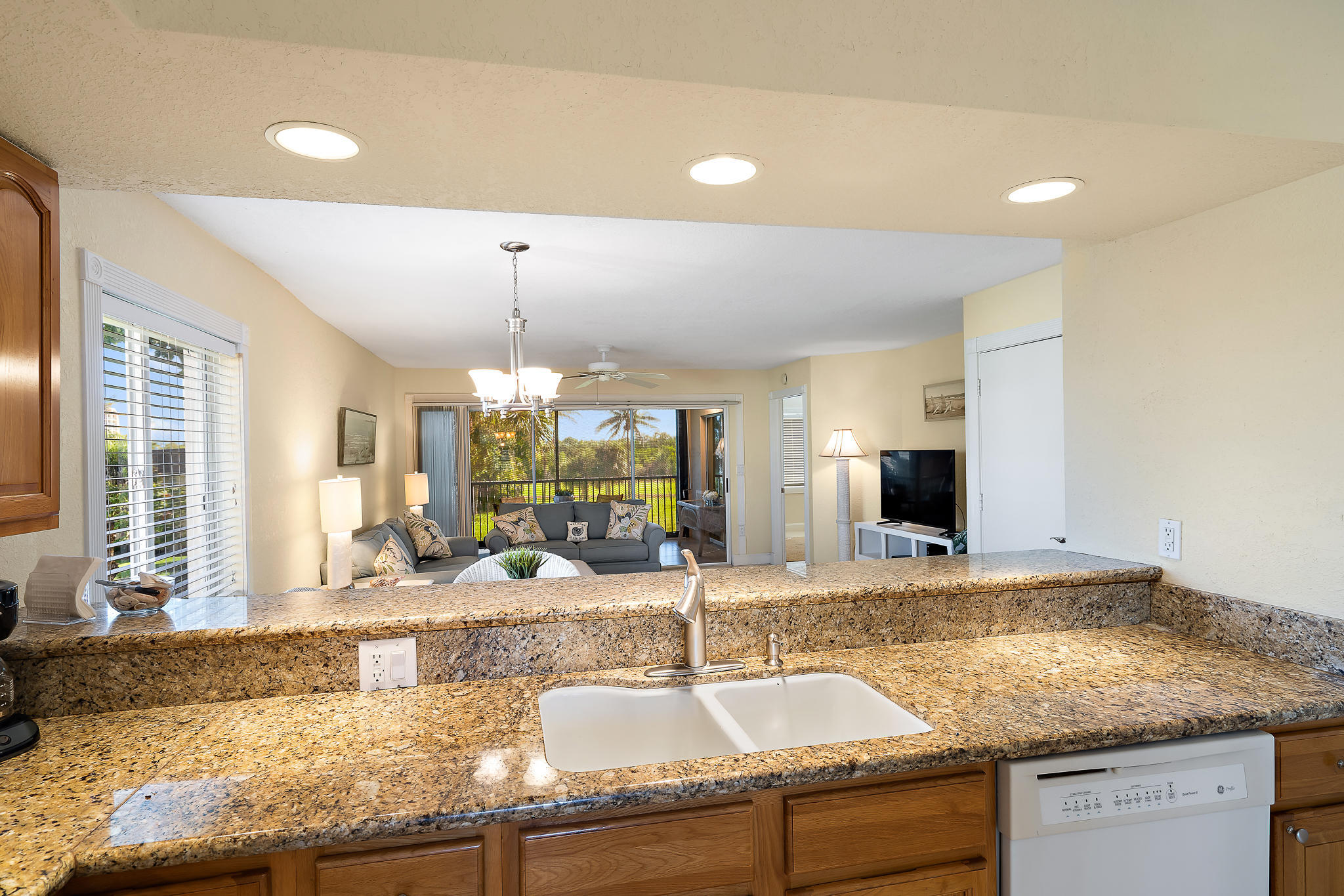 275 Palm Avenue, Unit C201 Jupiter, FL 33477 - Photo 16 of 24 a kitchen with granite countertop a sink and a counter top space