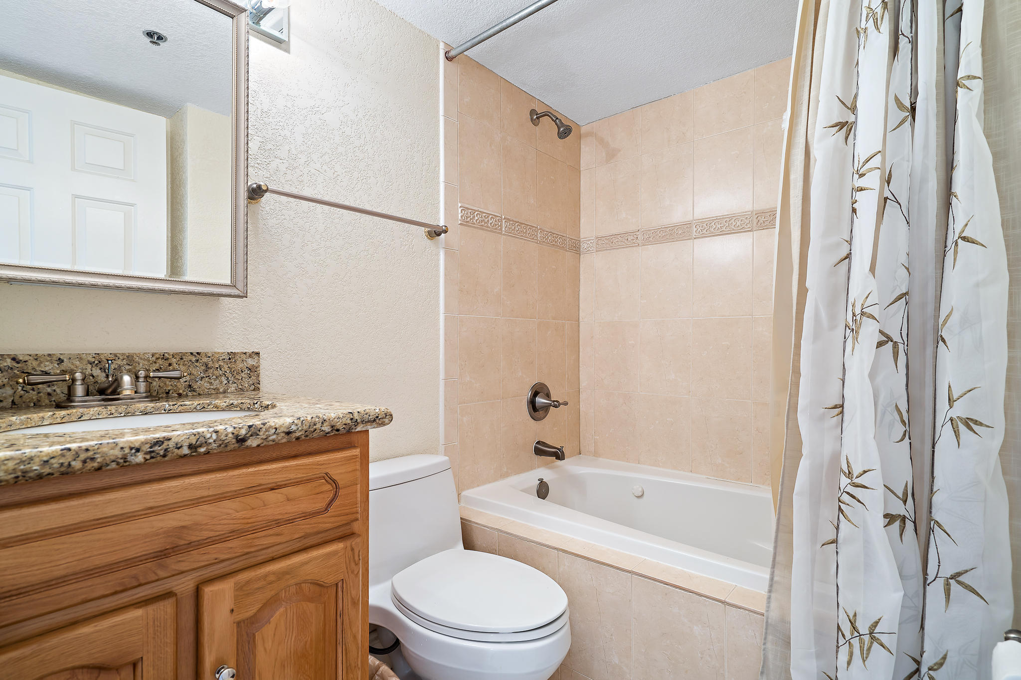 275 Palm Avenue, Unit C201 Jupiter, FL 33477 - Photo 20 of 24 a bathroom with a granite countertop sink toilet and shower