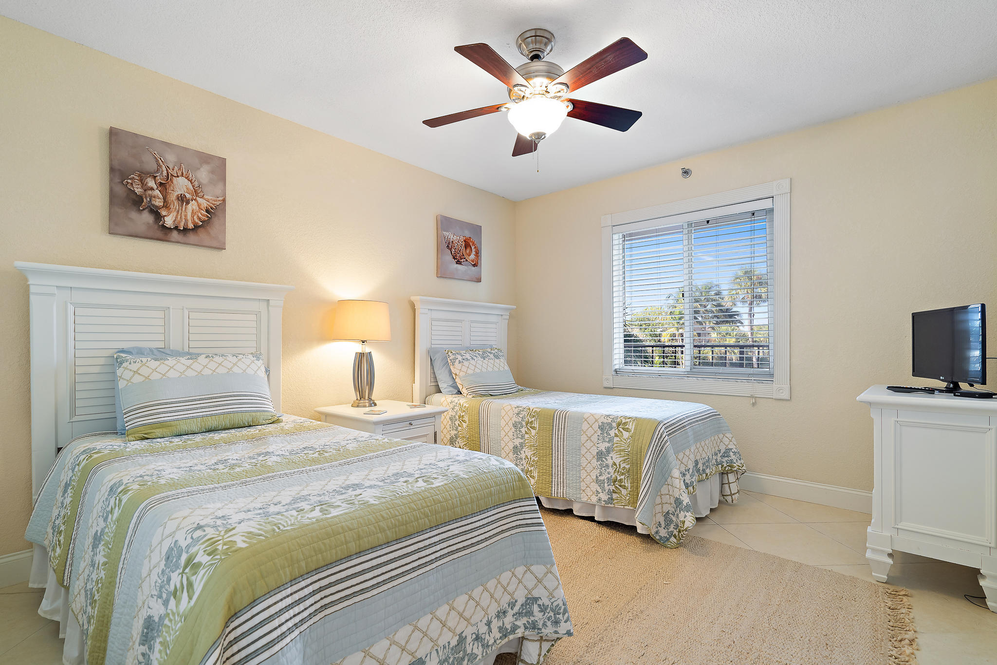 275 Palm Avenue, Unit C201 Jupiter, FL 33477 - Photo 21 of 24 a bedroom with a bed and a tv