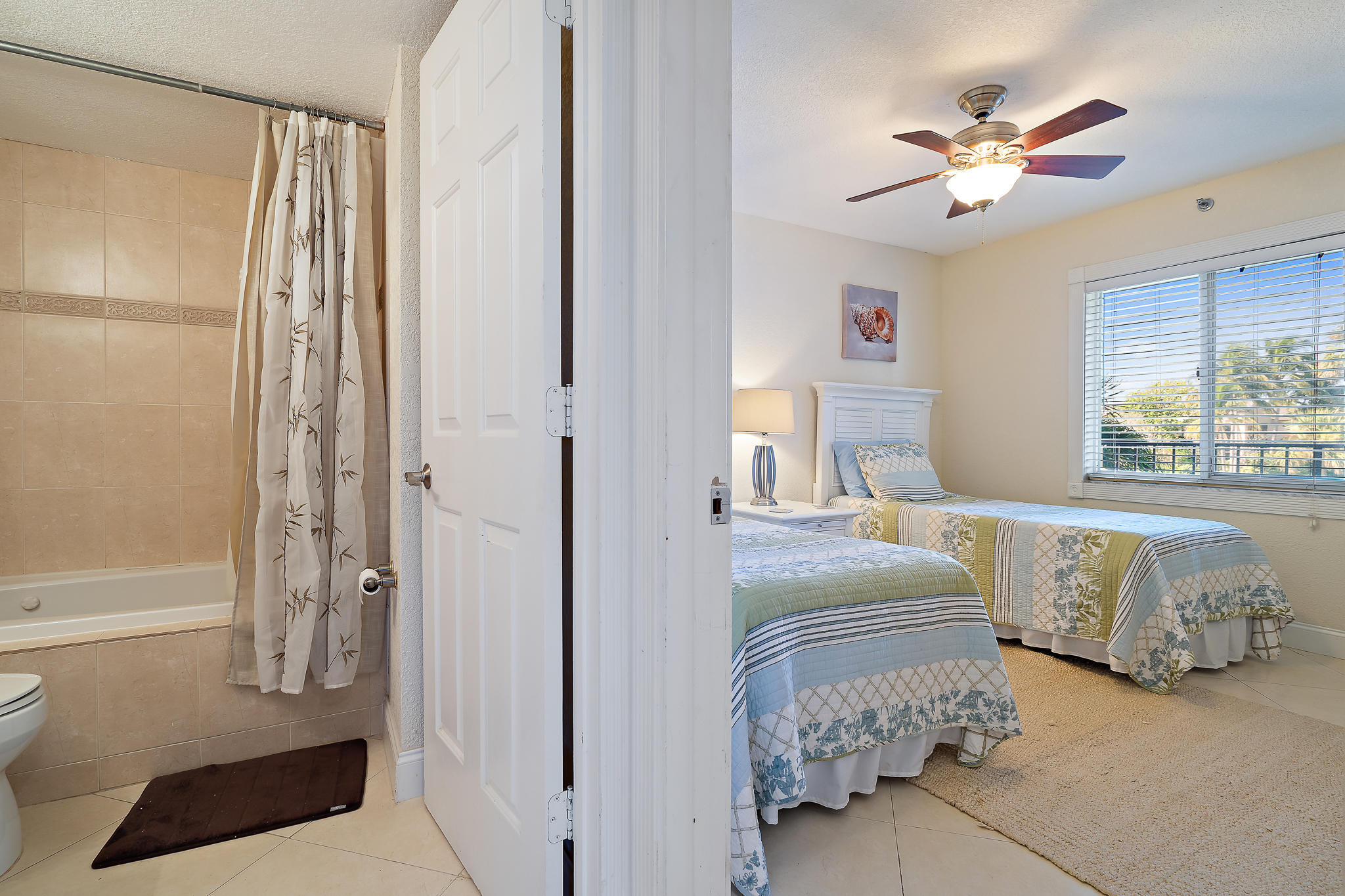 275 Palm Avenue, Unit C201 Jupiter, FL 33477 - Photo 22 of 24 a bedroom with a bed and a window with the outer view