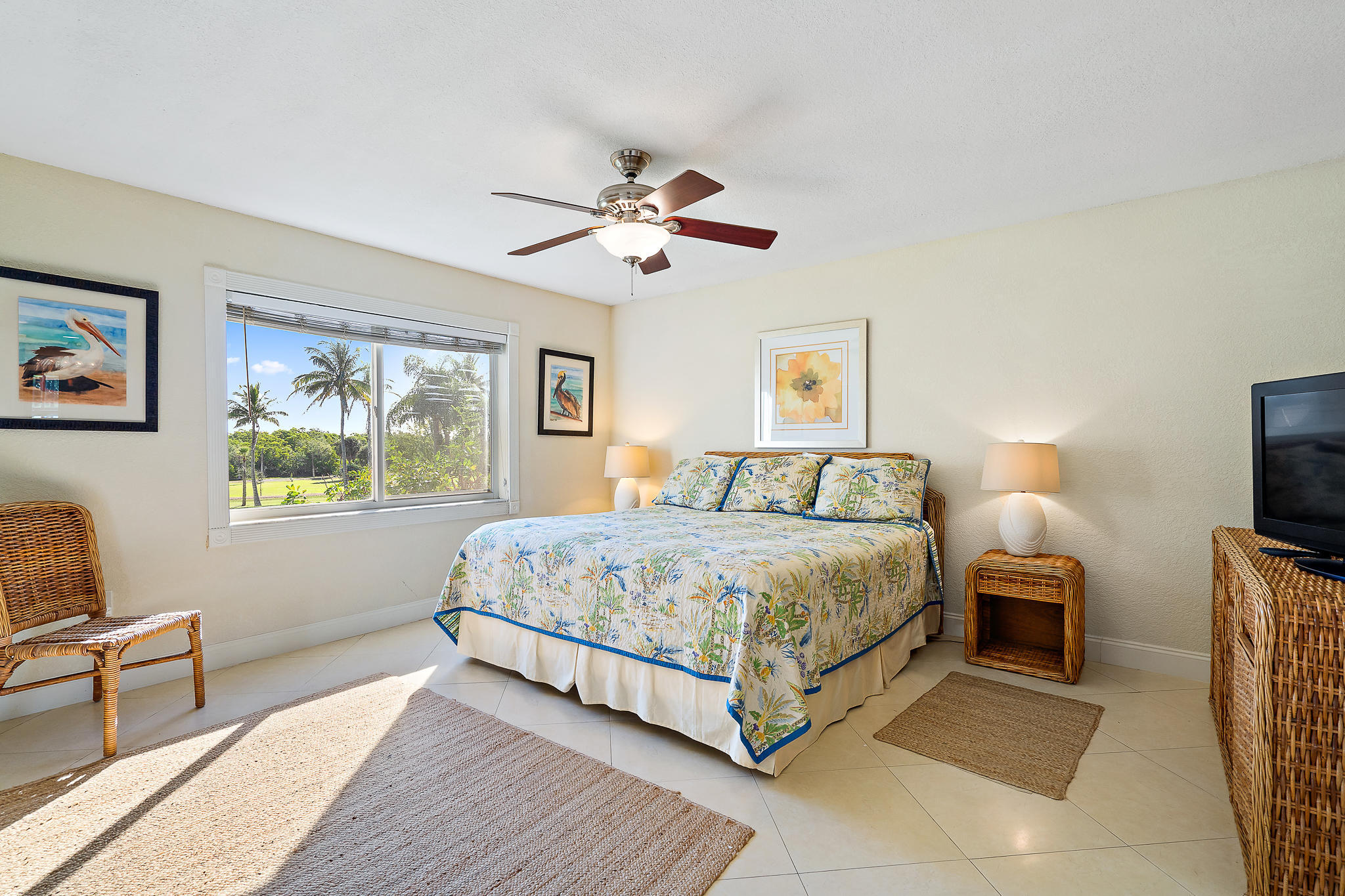 275 Palm Avenue, Unit C201 Jupiter, FL 33477 - Photo 6 of 24 a spacious bedroom with a bed and a tv