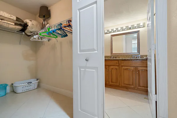 a bathroom with a granite countertop sink toilet a mirror and shower