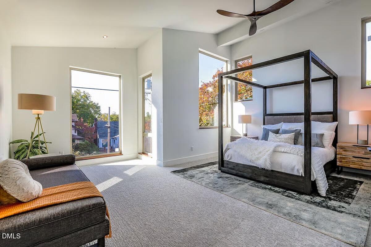 804 Cotton Place, Unit 102 Raleigh, NC 27601 - Photo 6 of 15 a bedroom with a bed couch and window