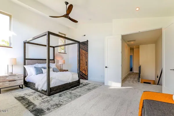 a bedroom with a bed and a mirror