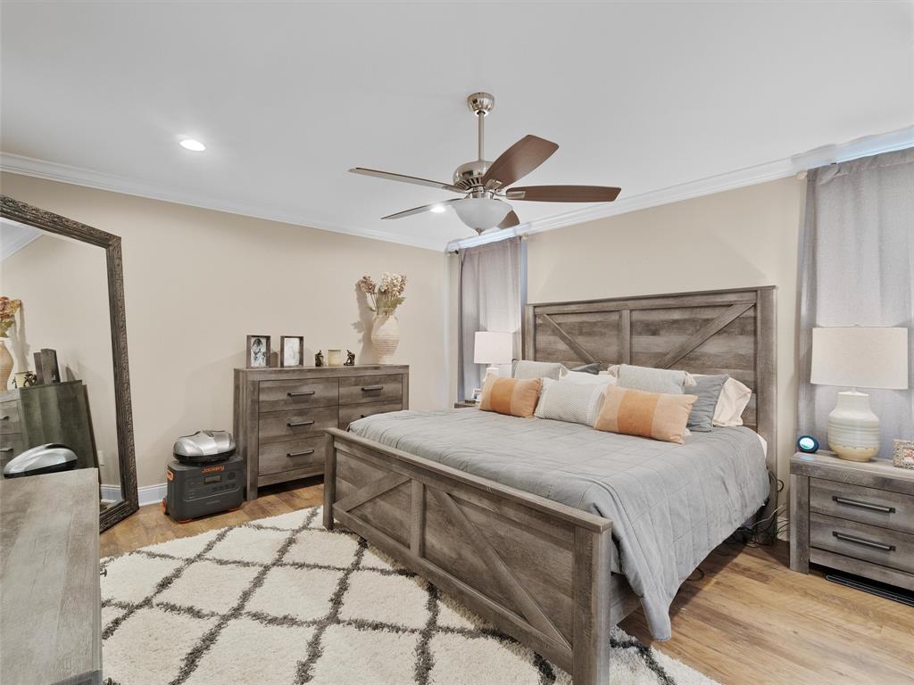 1103 Marigold Lane Longview, TX 75604 - Photo 20 of 34 a bedroom with a bed and dresser with mirror