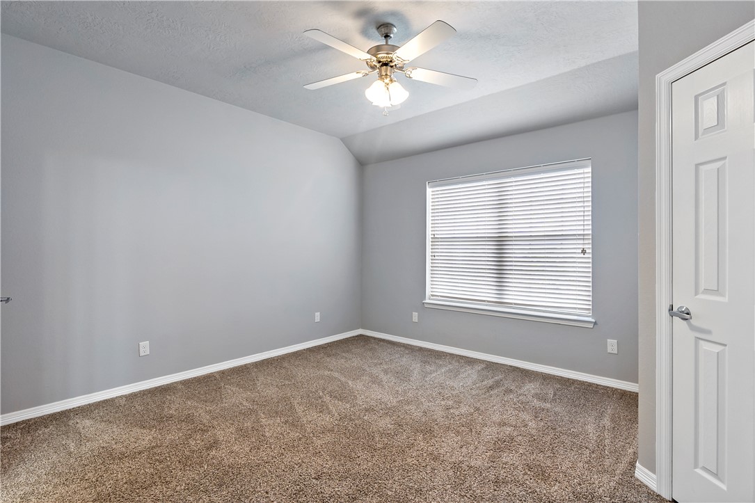 1198 Jones-Butler Road, Unit 1402 College Station, TX 77840 - Photo 19 of 20 an empty room with windows and ceiling fan