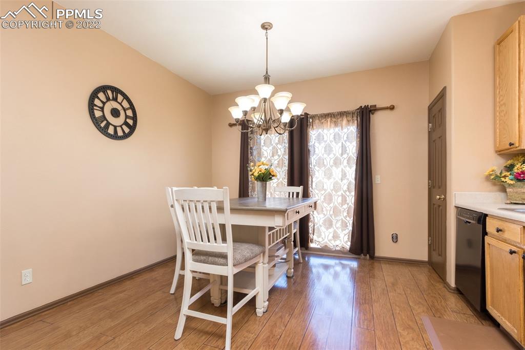 7542 Stephenville Road Peyton, CO 80831 - Photo 11 of 32 a view of a dining room with furniture window and wooden floor