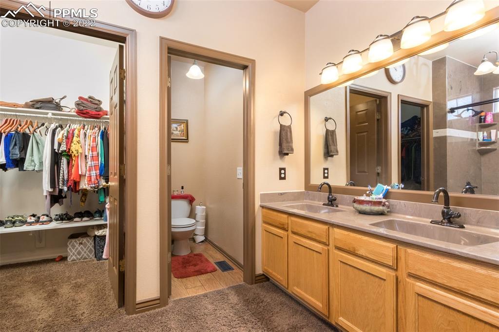 7542 Stephenville Road Peyton, CO 80831 - Photo 16 of 32 a en suite bathroom with a sink and a mirror
