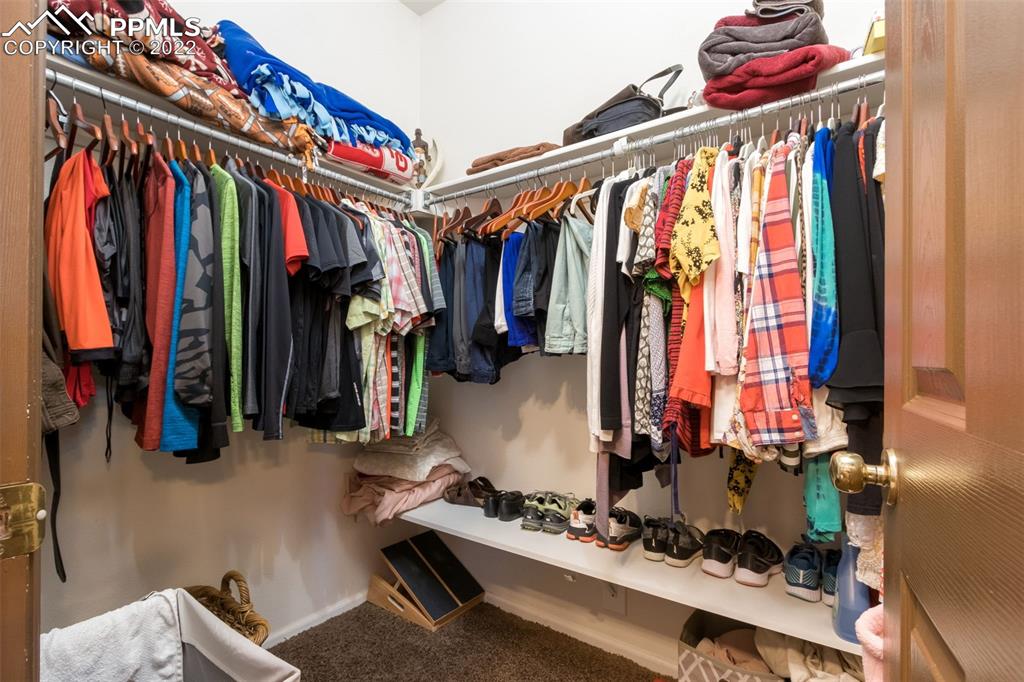 7542 Stephenville Road Peyton, CO 80831 - Photo 18 of 32 a view of walk in closet with clothes and shoes