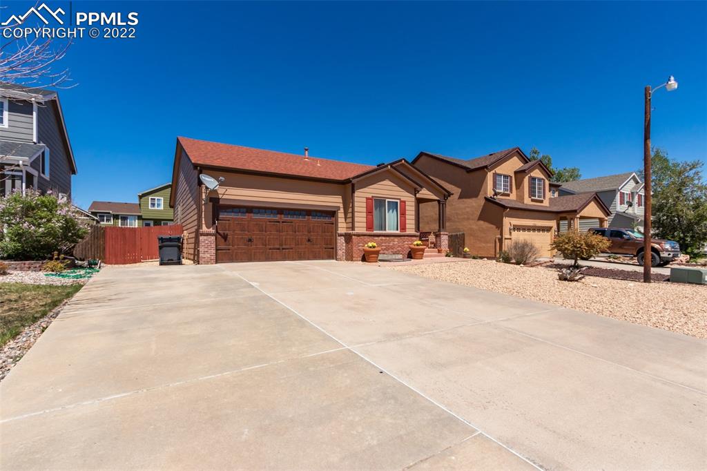 7542 Stephenville Road Peyton, CO 80831 - Photo 2 of 32 a front view of a house with a yard