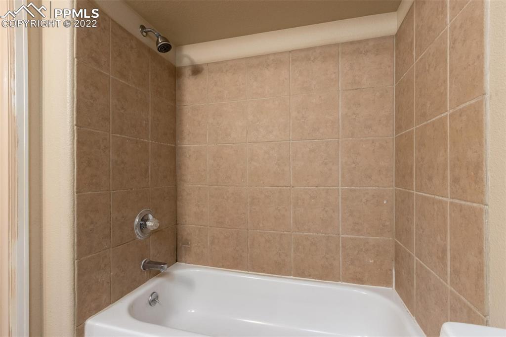 7542 Stephenville Road Peyton, CO 80831 - Photo 22 of 32 a bathroom with a shower and a bath tub