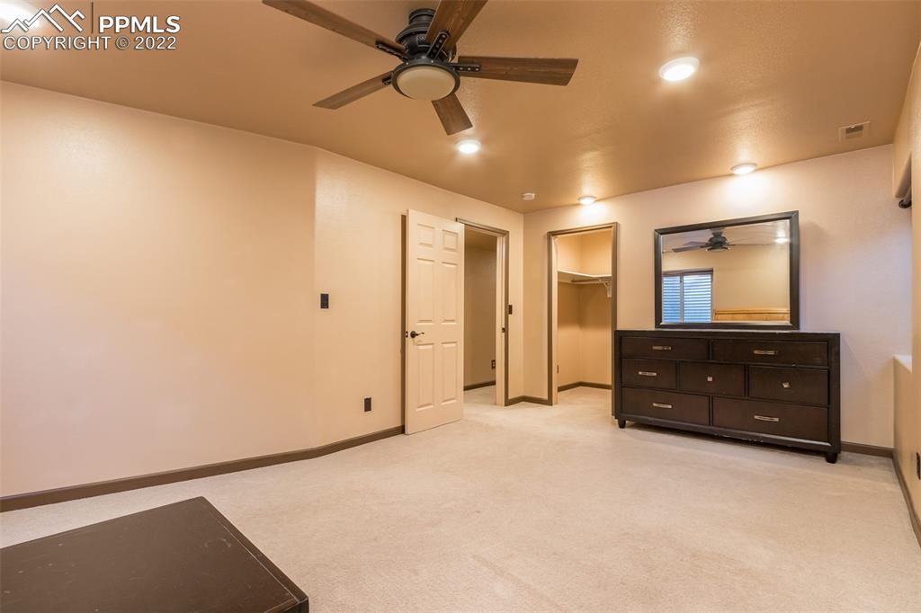 7542 Stephenville Road Peyton, CO 80831 - Photo 26 of 32 a view of a room with cabinet mirror and a ceiling fan
