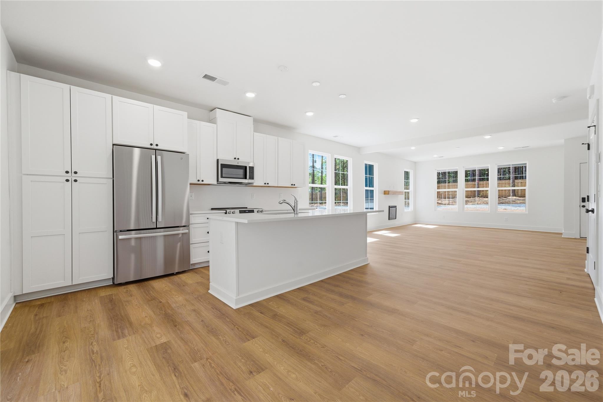 1412 Quiver Way York, SC 29745 - Photo 11 of 43 a large kitchen with stainless steel appliances a refrigerator and a stove top oven