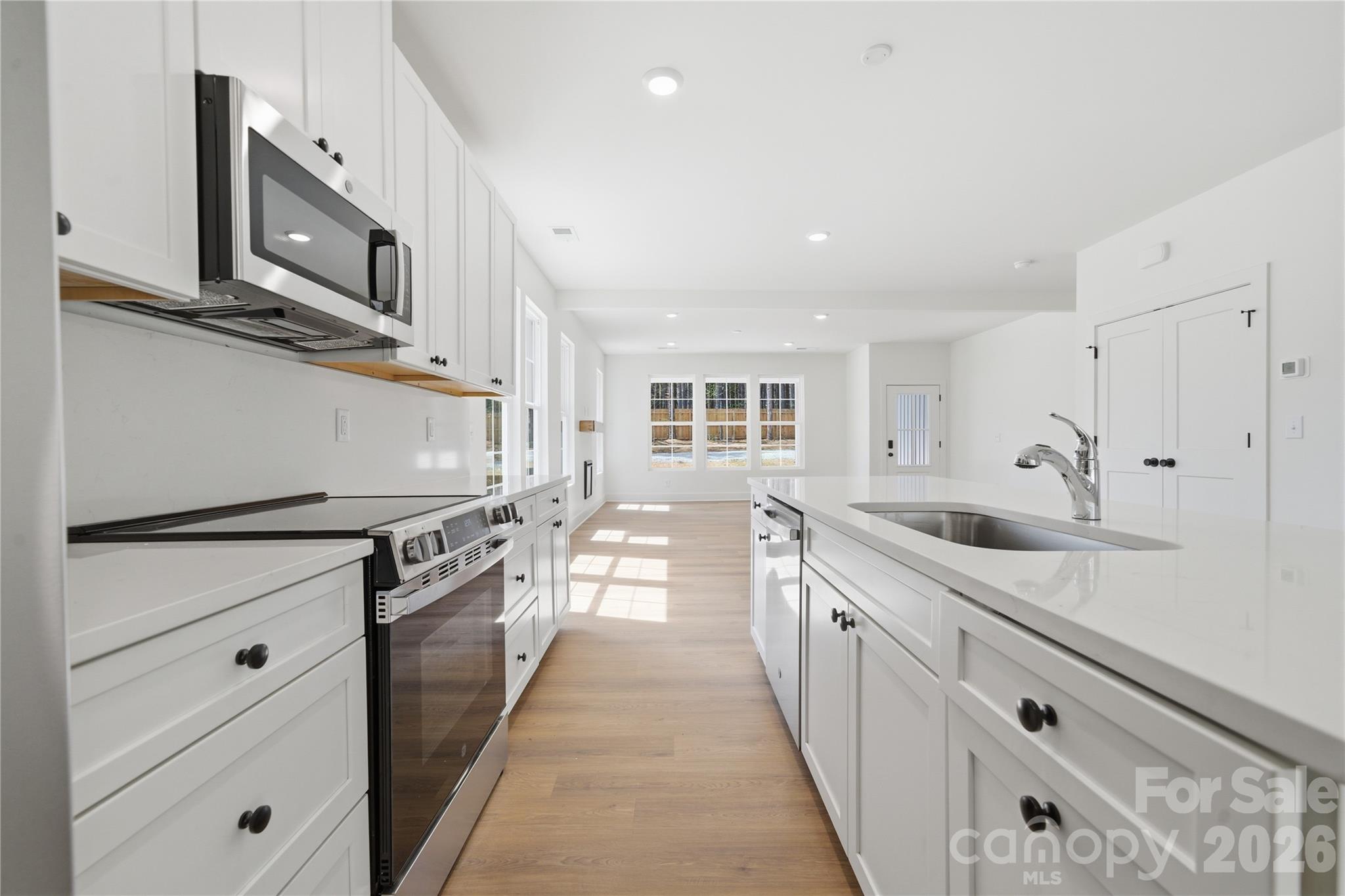 1412 Quiver Way York, SC 29745 - Photo 13 of 43 a large kitchen with stainless steel appliances granite countertop a lot of counter space and wooden floors