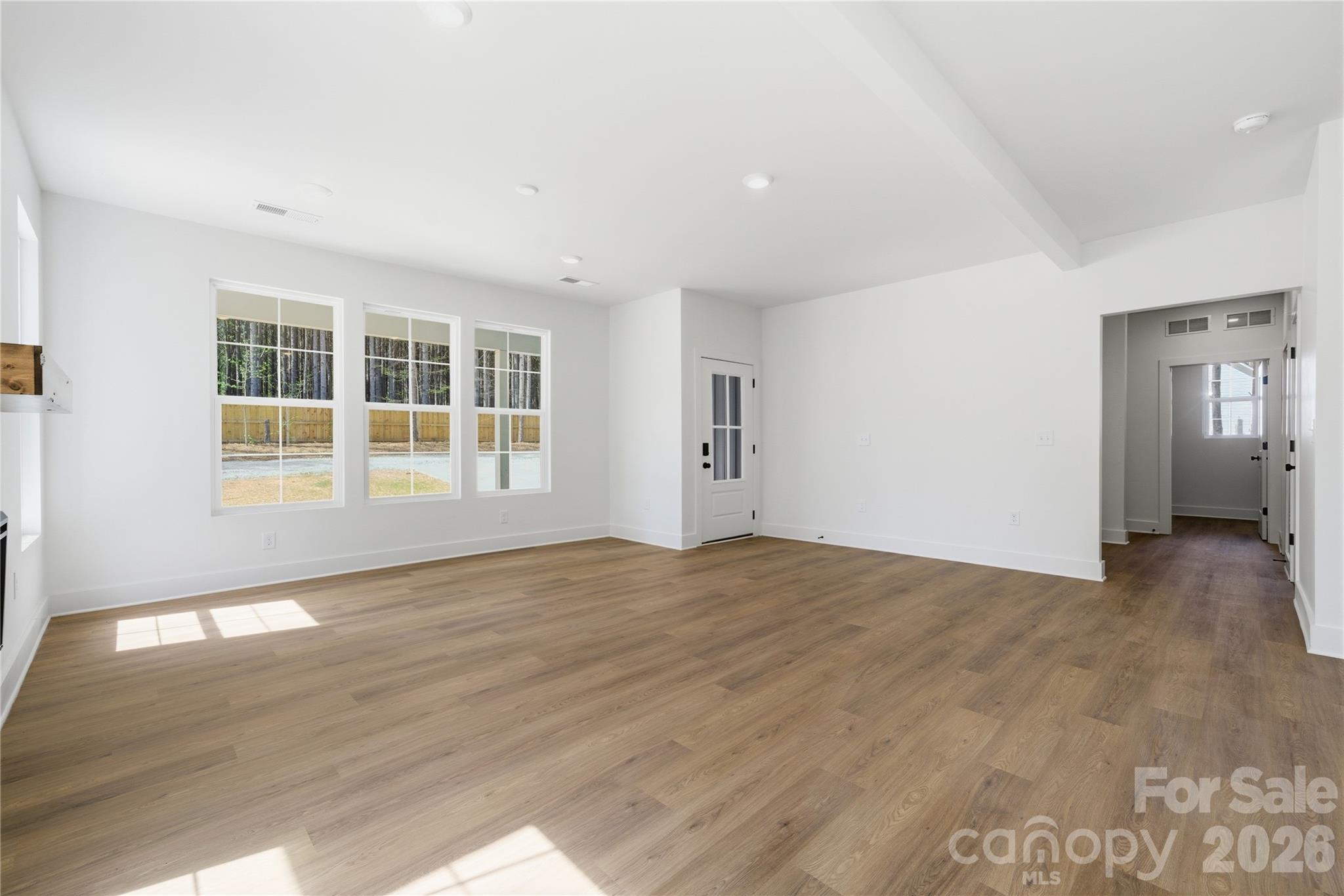 1412 Quiver Way York, SC 29745 - Photo 7 of 43 an empty room with wooden floor and windows