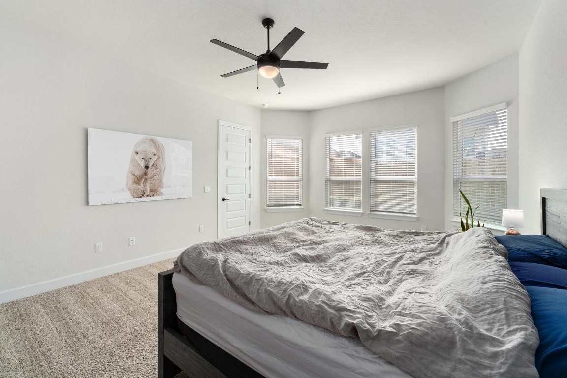 4513 Sea Salt Drive Austin, TX 78747 - Photo 14 of 31 a bedroom with a bed and a large window