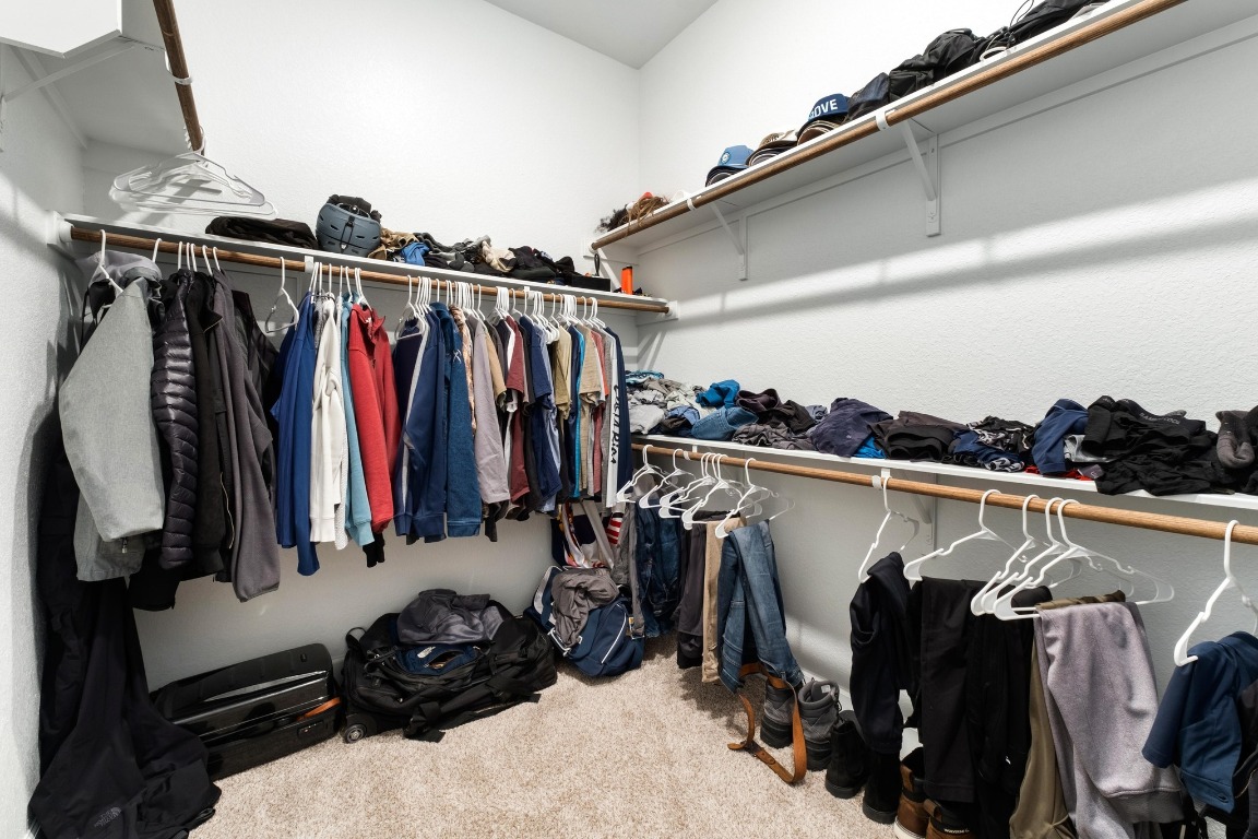 4513 Sea Salt Drive Austin, TX 78747 - Photo 18 of 31 a view of walk in closet with clothes and shoes