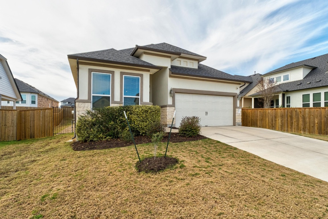 4513 Sea Salt Drive Austin, TX 78747 - Photo 2 of 31 a front view of a house with a yard and potted plants