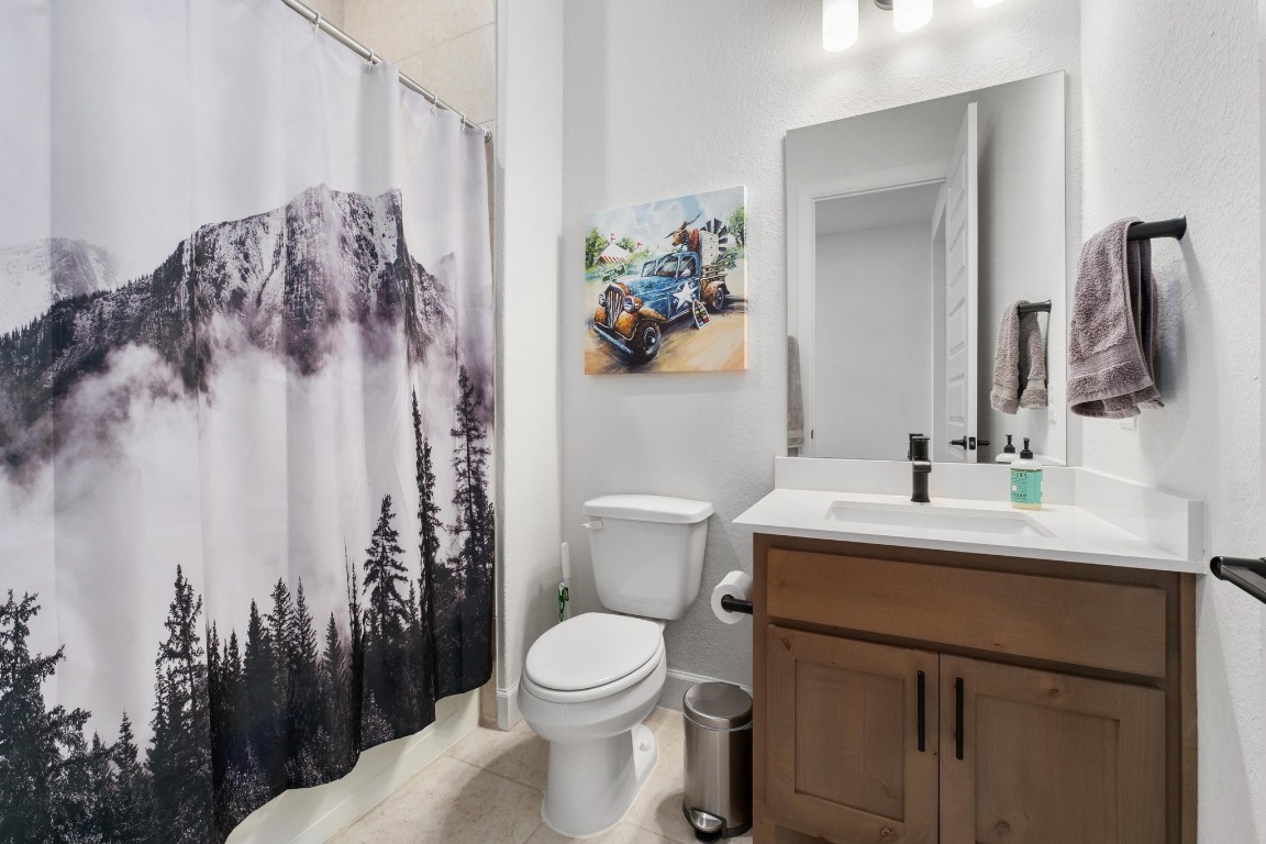 4513 Sea Salt Drive Austin, TX 78747 - Photo 21 of 31 a bathroom with a toilet sink and mirror