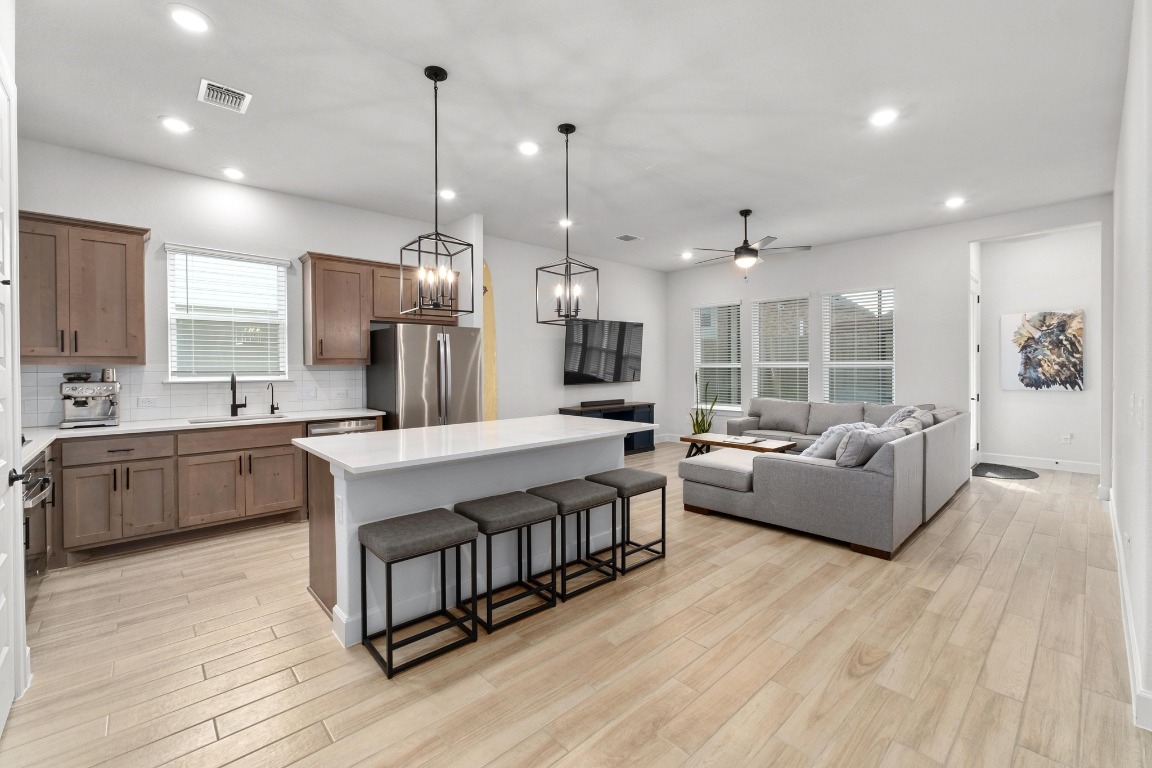 4513 Sea Salt Drive Austin, TX 78747 - Photo 6 of 31 a large living room with stainless steel appliances kitchen island granite countertop a couch and a view of living room