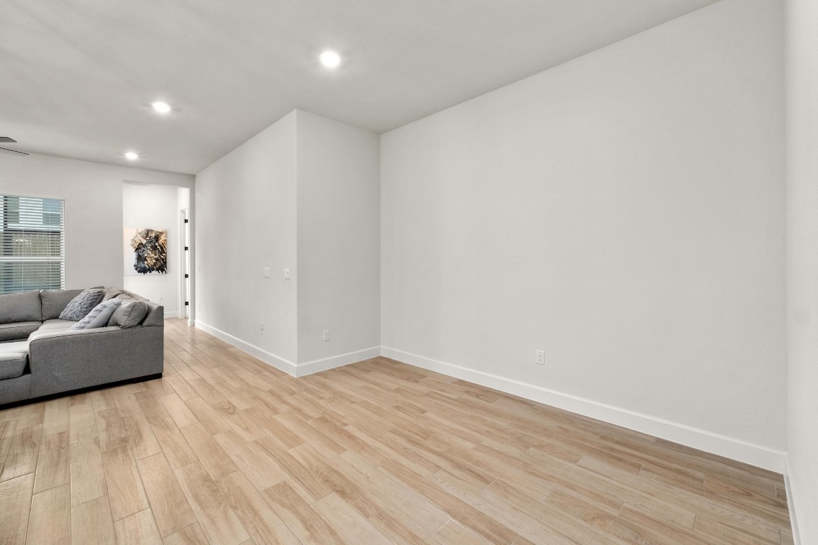 4513 Sea Salt Drive Austin, TX 78747 - Photo 10 of 31 a view of an empty room with wooden floor and a window