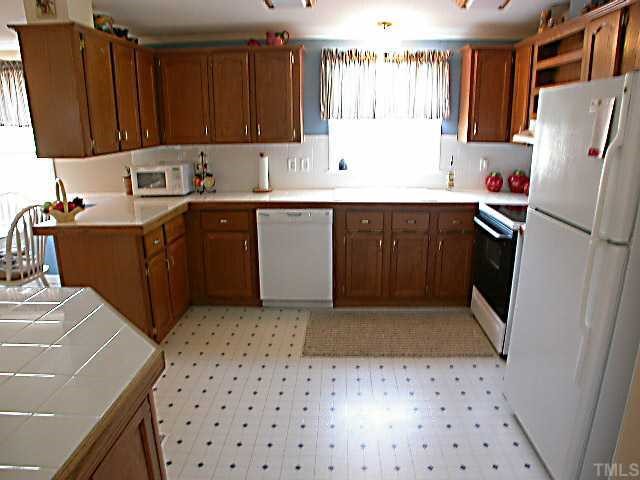 Kitchen with tile countertops & backsplash