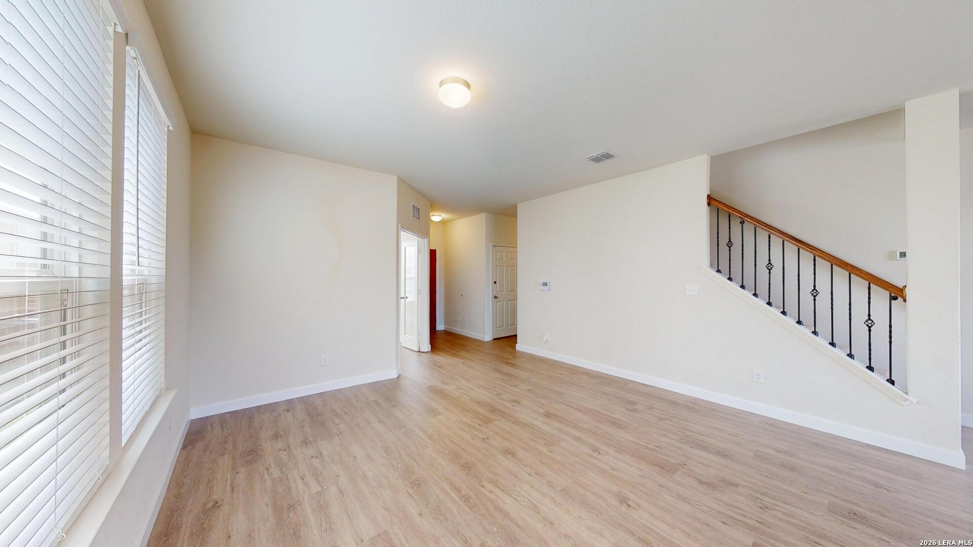 344 Autumn Rouge New Braunfels, TX 78130 - Photo 6 of 16 a view of an empty room with wooden floor and a window