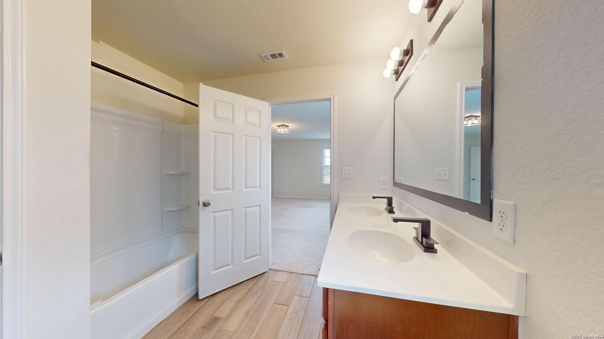 344 Autumn Rouge New Braunfels, TX 78130 - Photo 9 of 16 a bathroom with a sink mirror and shower