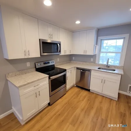 a kitchen with a stove a sink and a microwave