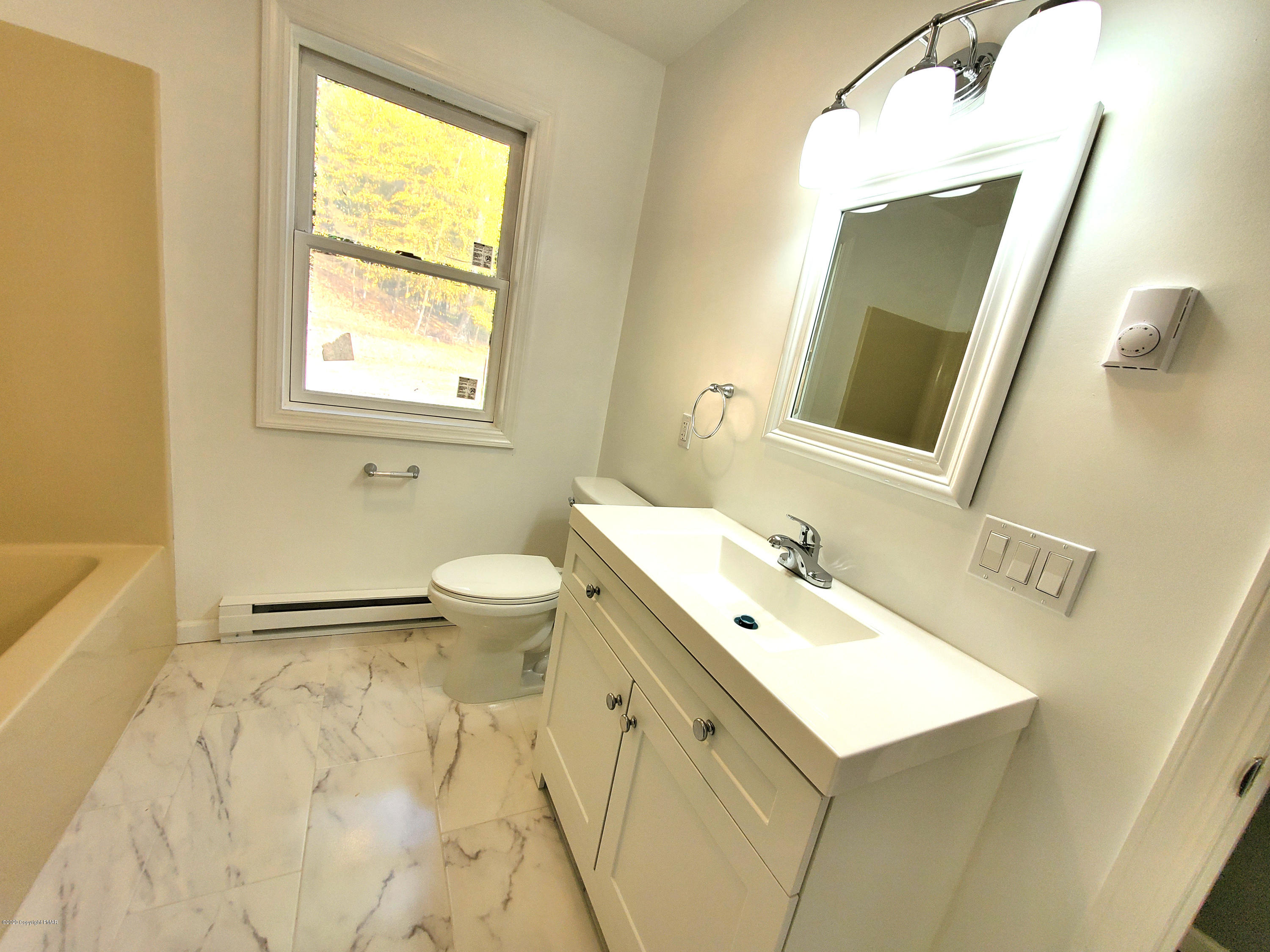 2273 Milford Road Bushkill, PA 18324 - Photo 12 of 23 a bathroom with a sink a toilet and a mirror