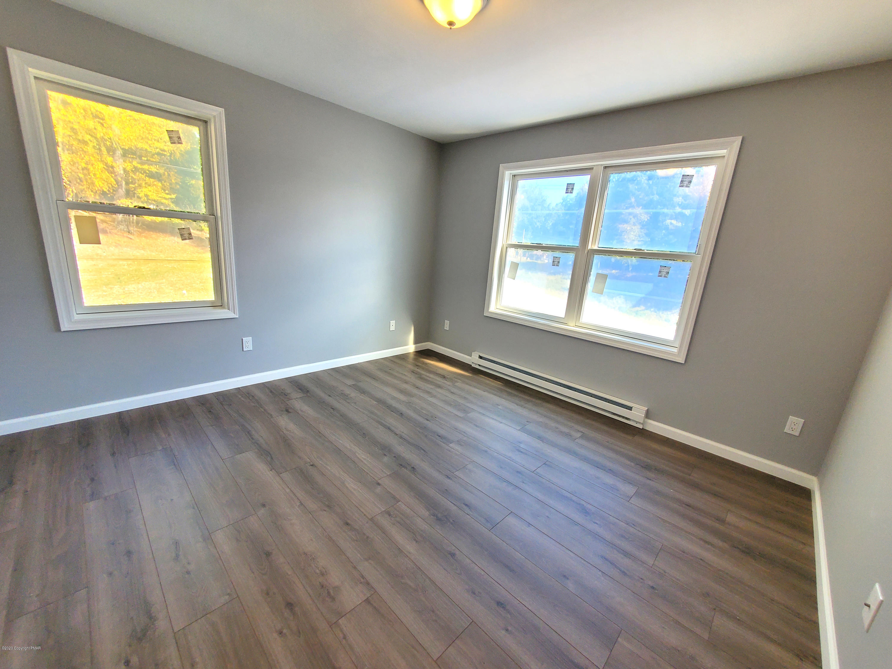 2273 Milford Road Bushkill, PA 18324 - Photo 6 of 23 a view of an empty room with wooden floor and a window