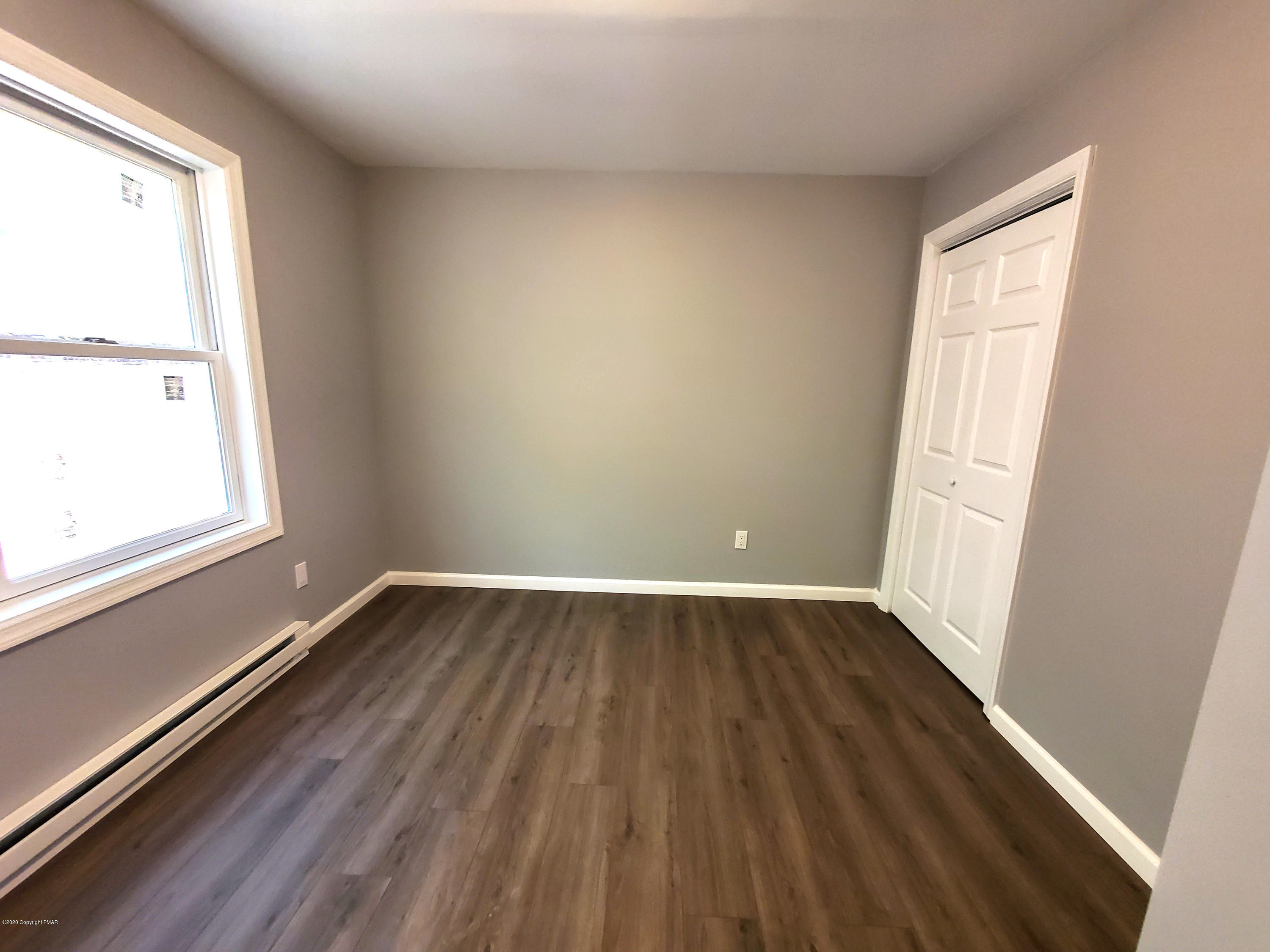 2273 Milford Road Bushkill, PA 18324 - Photo 8 of 23 an empty room with wooden floor and windows