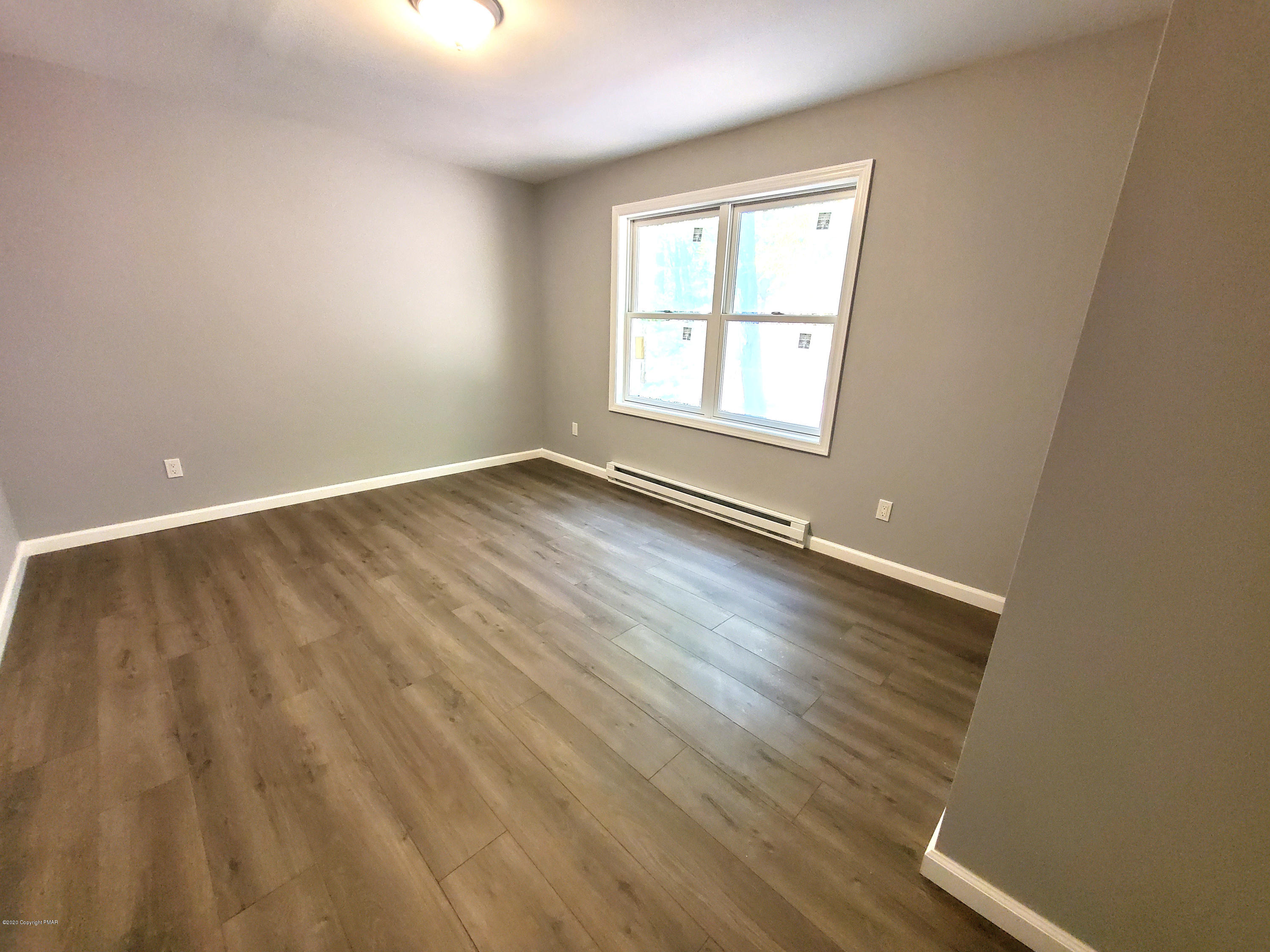 2273 Milford Road Bushkill, PA 18324 - Photo 9 of 23 an empty room with wooden floor and windows