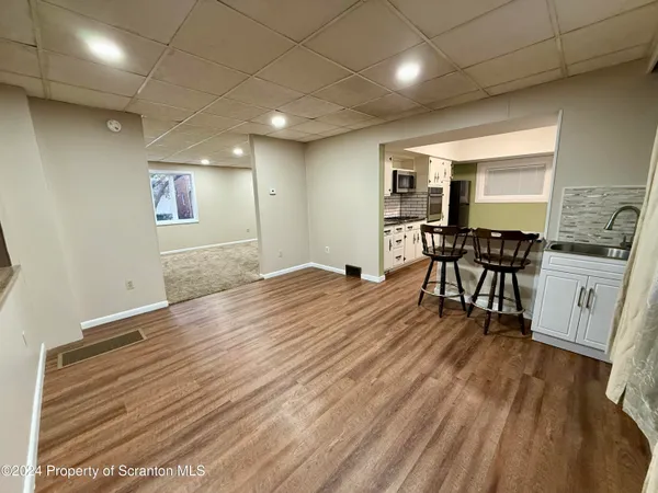 a view of a room with wooden floor