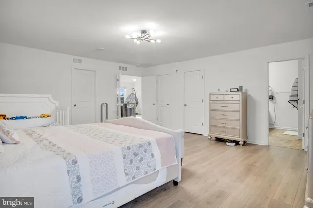 a spacious bedroom with a bed and a cabinets