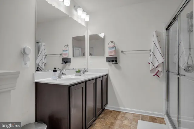 a bathroom with a sink a mirror and shower