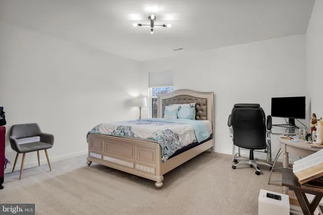 a bedroom with a bed and a chair