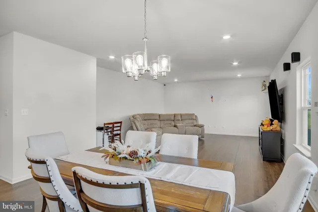 a view of a dining room with furniture and chandelier