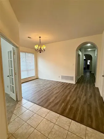 wooden floor in an empty room with a mirror
