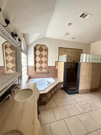 a bathroom with a tub sink and mirror