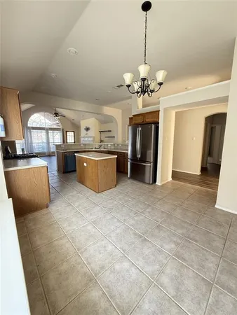 a view of a kitchen with a sink and a chandelier