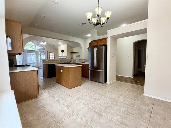 a view of a kitchen with stainless steel appliances granite countertop a refrigerator and a sink