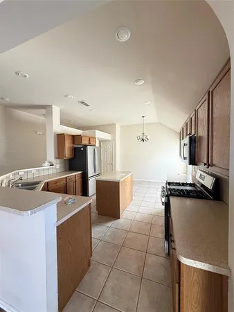 a open kitchen with stainless steel appliances granite countertop a sink and a stove