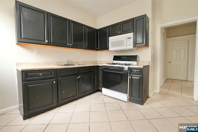 a kitchen with a stove top oven sink and cabinets