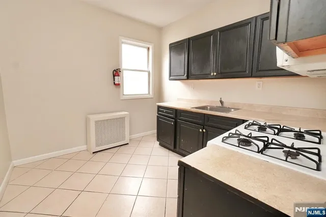 a kitchen with a sink cabinets and appliances