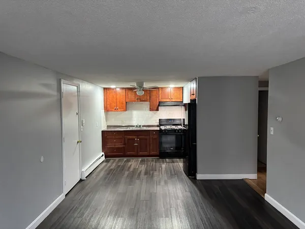 a kitchen with granite countertop wooden floors and stainless steel appliances