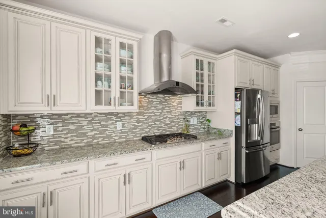 a kitchen with stainless steel appliances granite countertop a refrigerator sink and cabinets