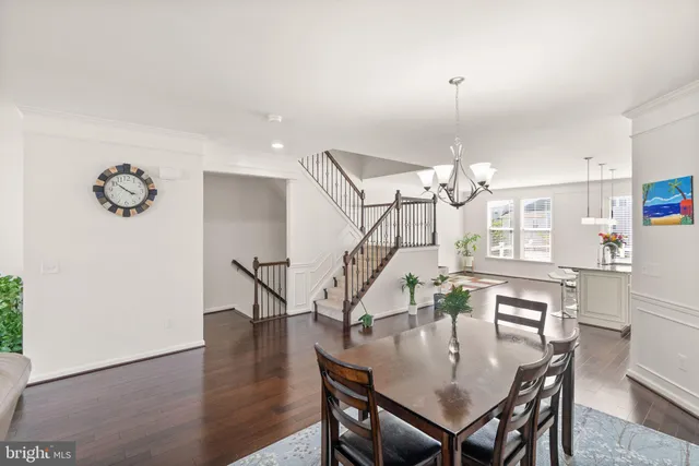 a dining room with furniture and wooden floor